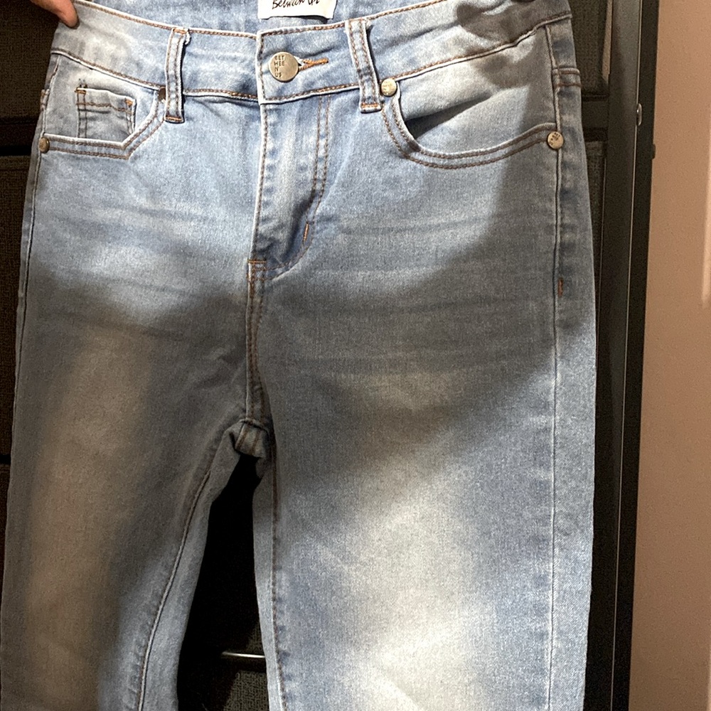 Between us. Light colored washed jeans very cute fit tightly size 5 .